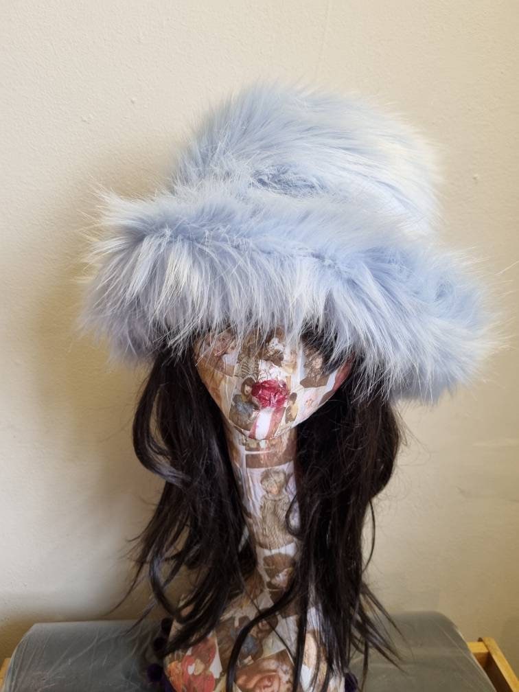 Baby blue fluffy faux fur bucket hat — second side angle on mannequin, highlighting soft pile depth and hat shape