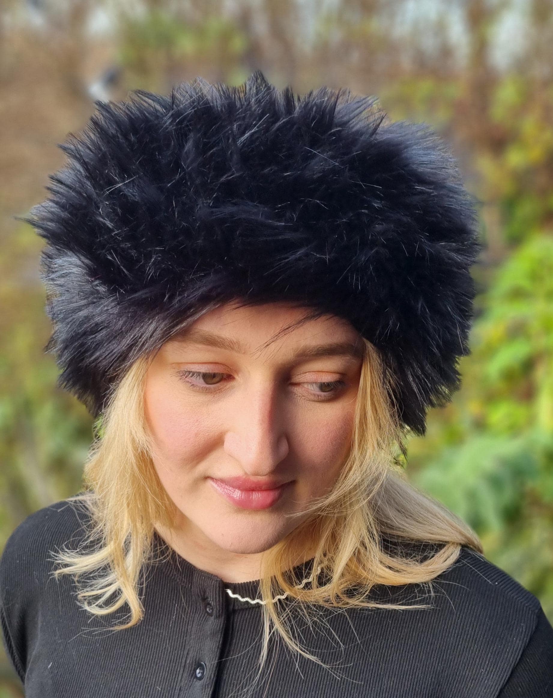Person wearing a black furry headband background