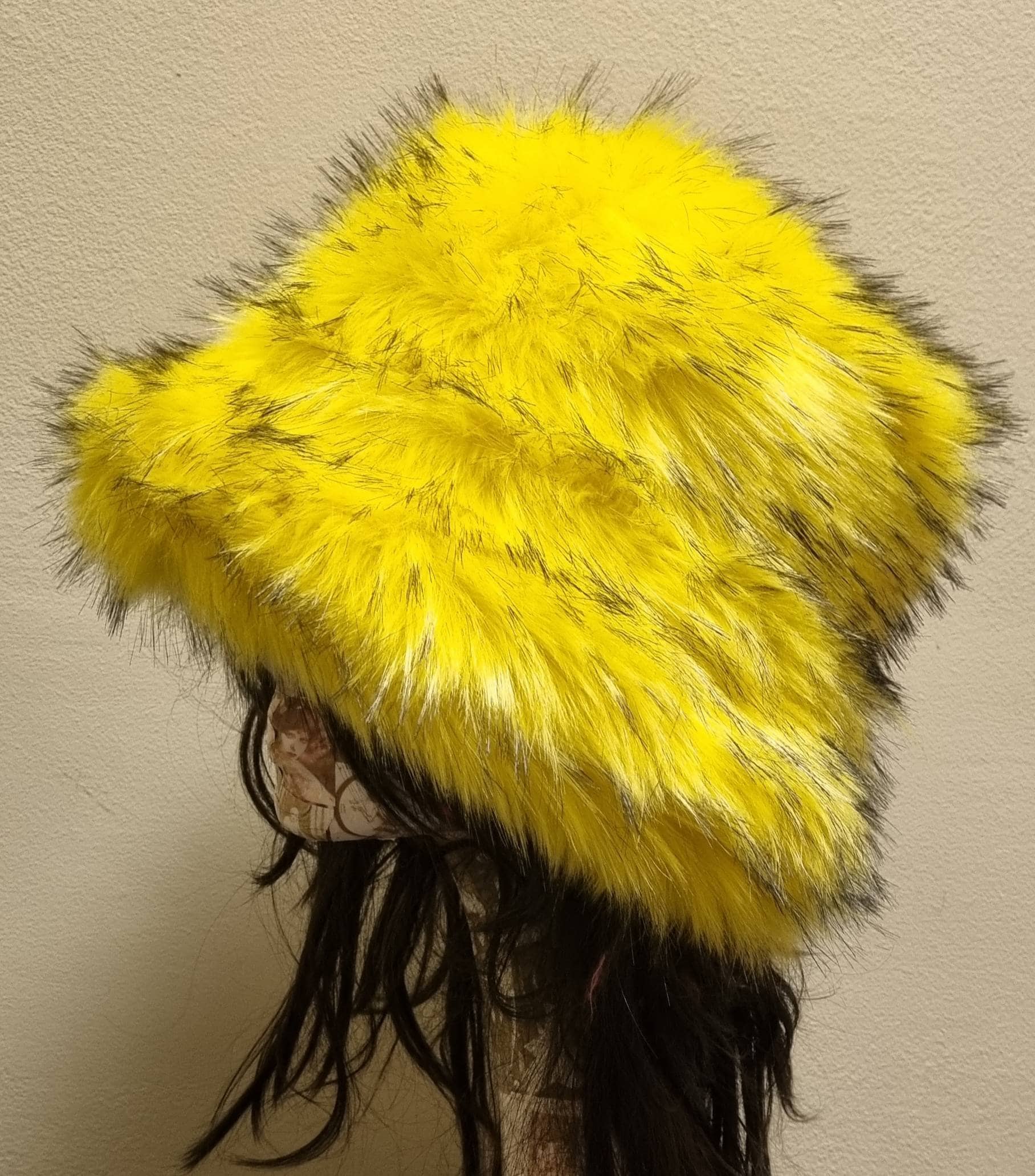 Canary yellow faux fur bucket hat — side angle on mannequin showing fluffy fur depth and volume