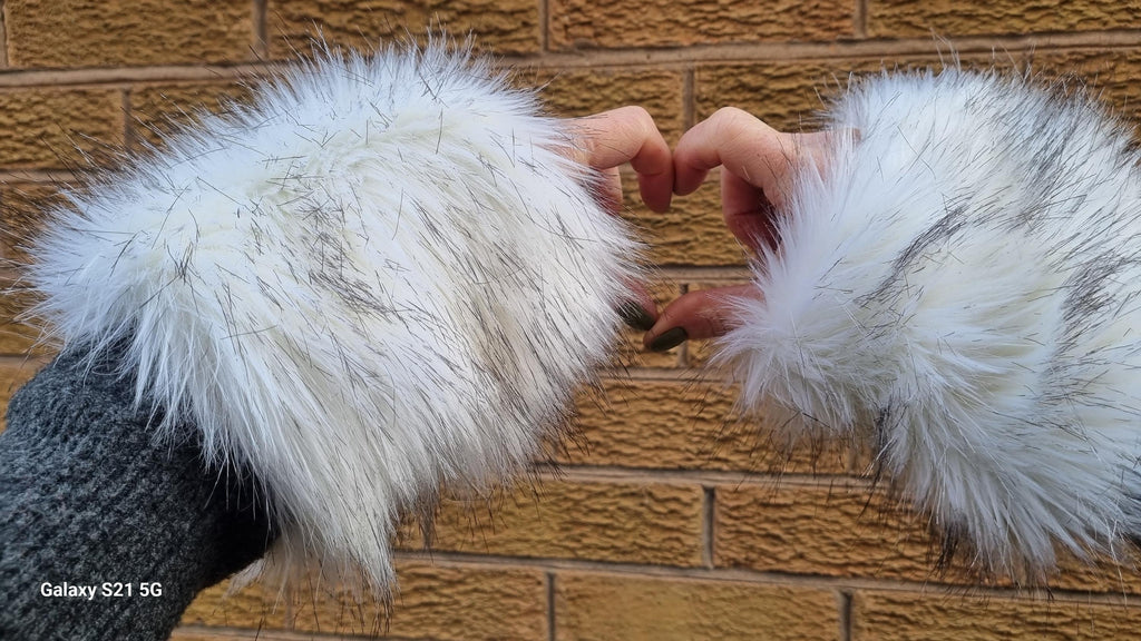 Fluffy white fur wrist warmers with dark black tips fleece lined
