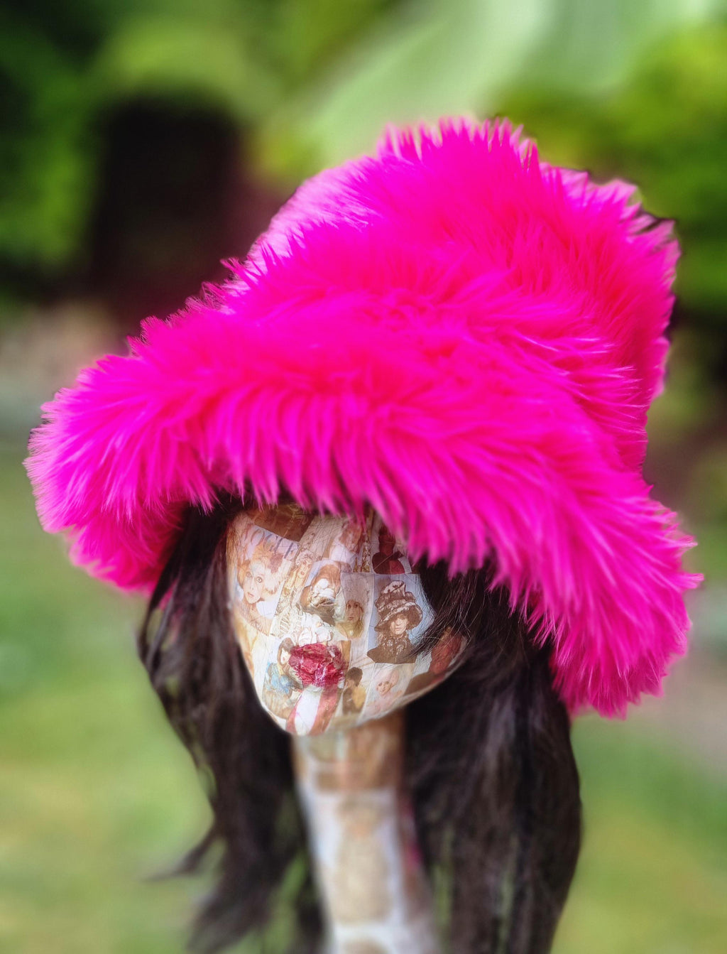 Shaggy shocking pink faux fur bucket hat — front view on mannequin outdoors, vivid hot pink twisty fur texture, handmade in the UK