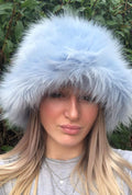 Baby blue fluffy faux fur bucket hat — front view worn by a person, soft cloud-like baby blue pile, handmade in the UK