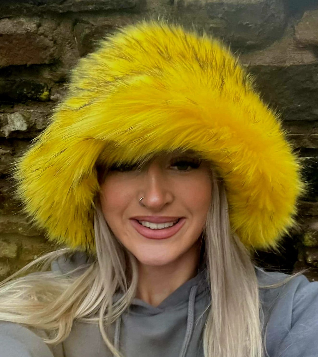 Canary yellow faux fur bucket hat — front view on model, vivid yellow fluffy faux fur, handmade in the UK