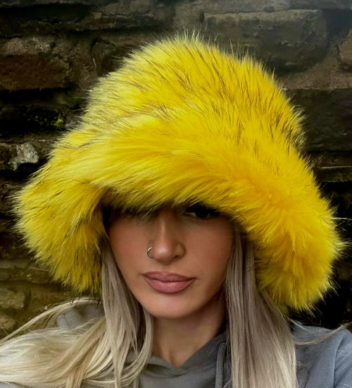 canary yellow faux fur bucket hat — front view on model showing full hat shape and bright yellow tones