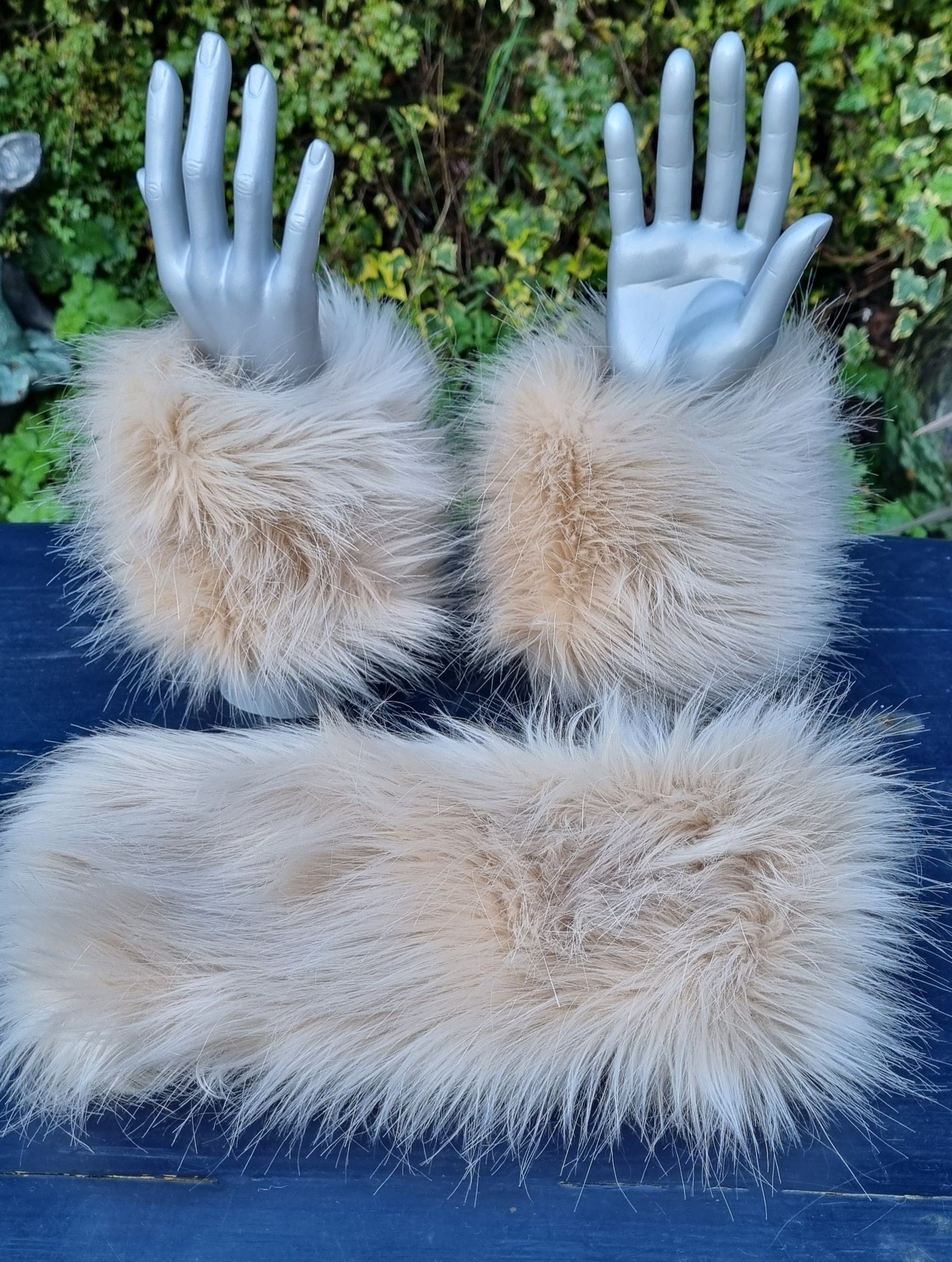 Beige fur cuffs on with a matching fluffy headband 