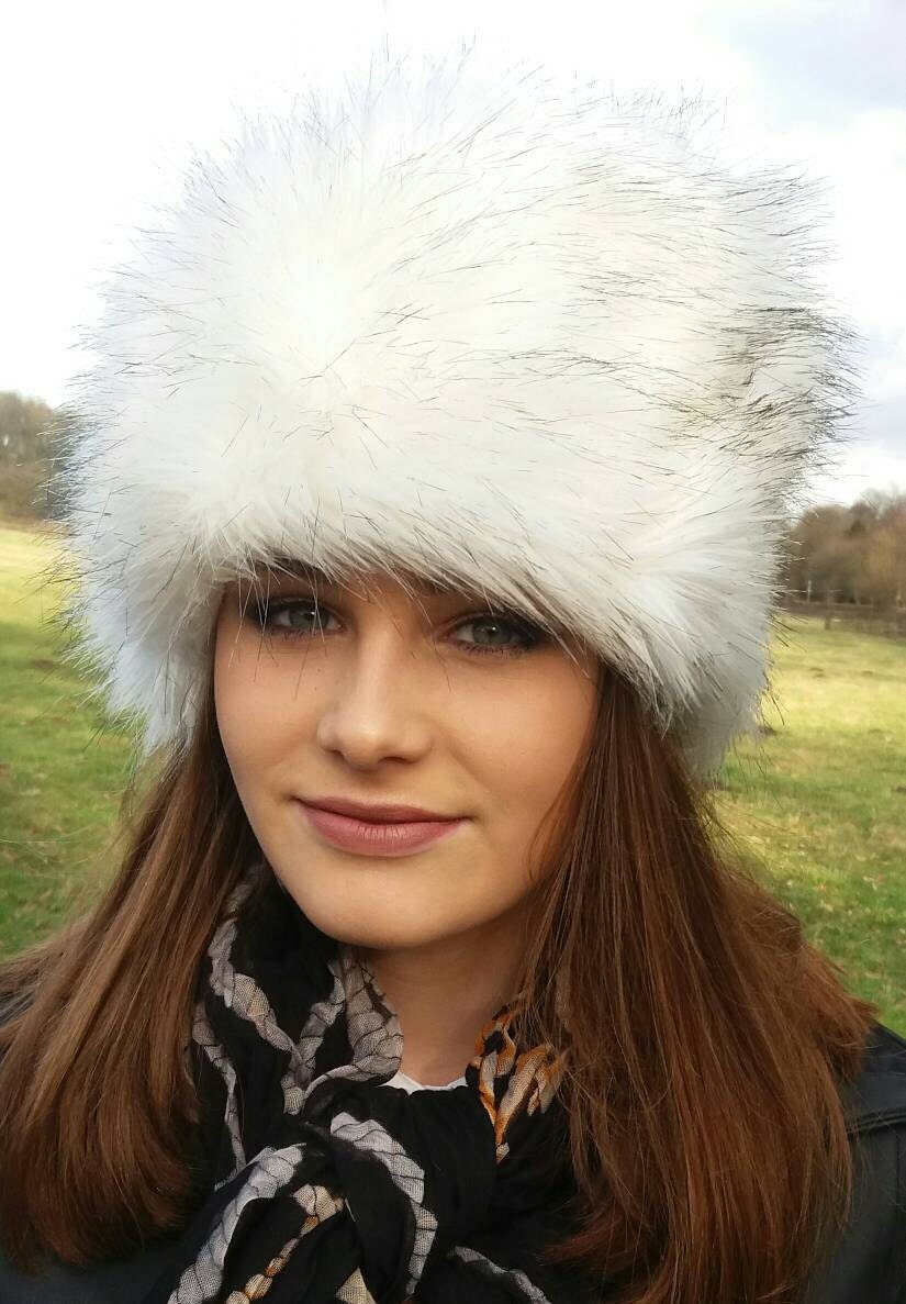 Woman wearing a white fur hat outdoors