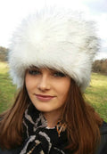 Woman wearing a white fur hat outdoors