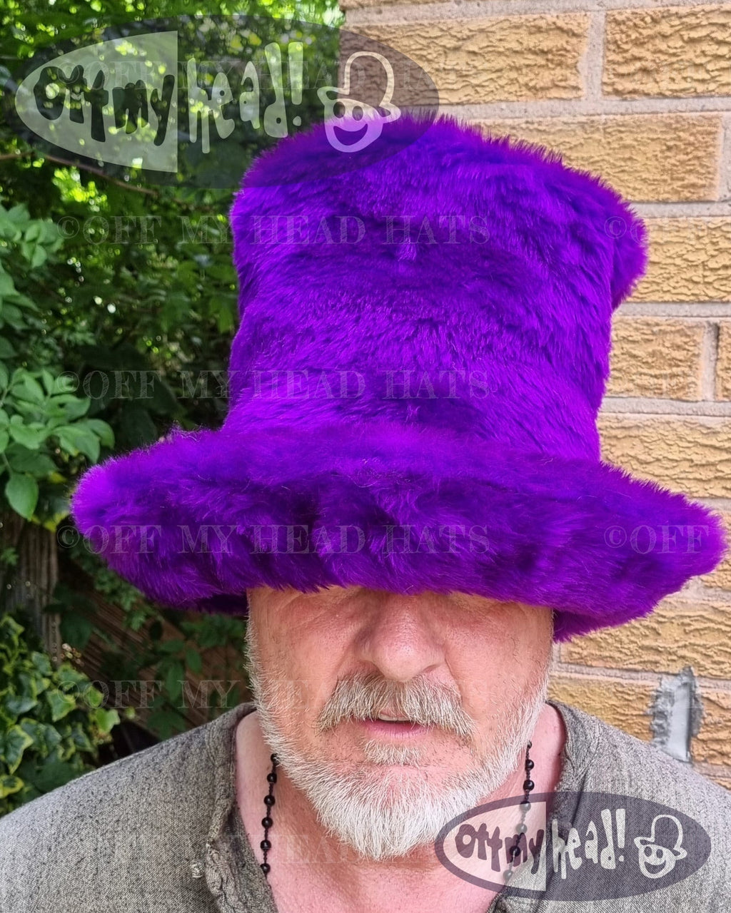 Person wearing a purple fur hat with 'Off My Head' brandingtall JK style hat