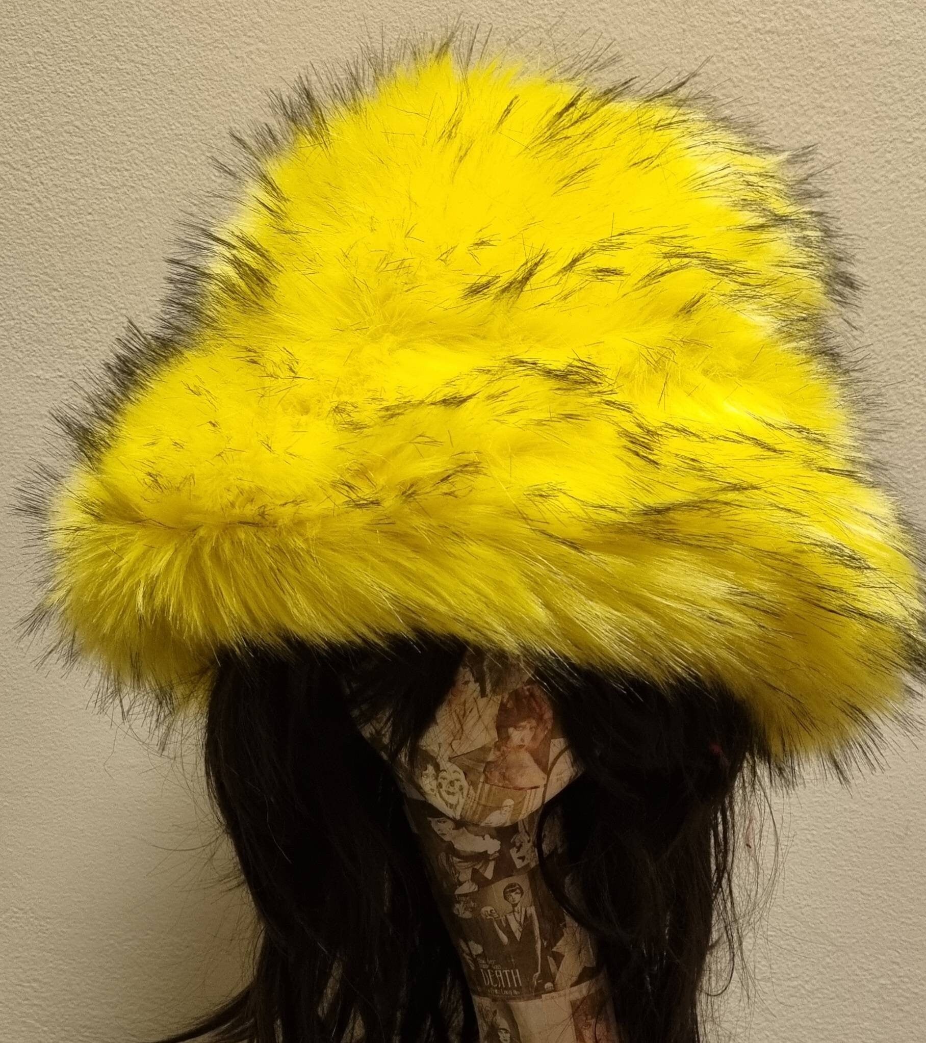 Canary yellow faux fur bucket hat — close-up on mannequin head showing vivid yellow and fluffy fur detail